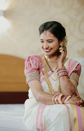 Woman in white and pink traditional saree